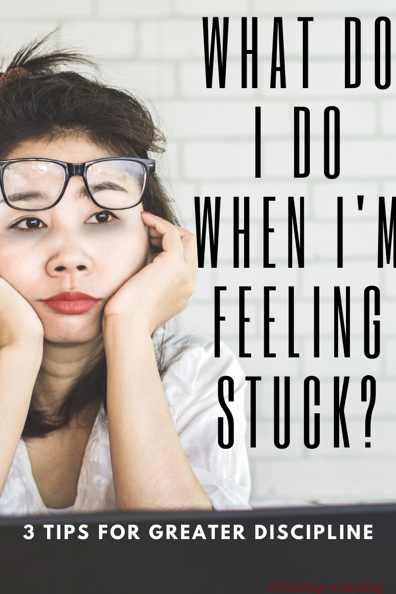 Frustrated woman with glasses pushed up her forehead asking what do I do when I'm feeling stuck?